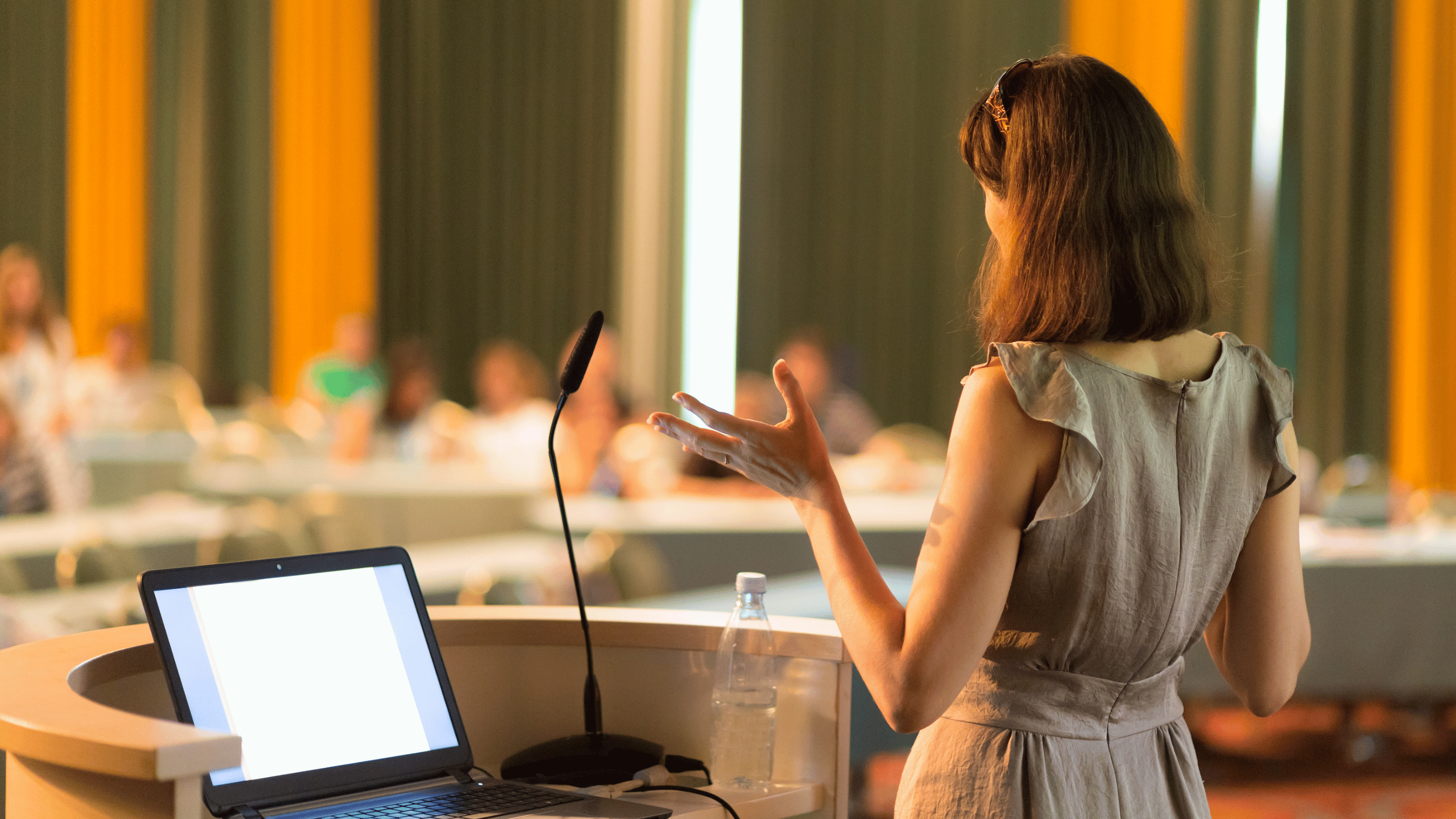 person making a presentation at a podium