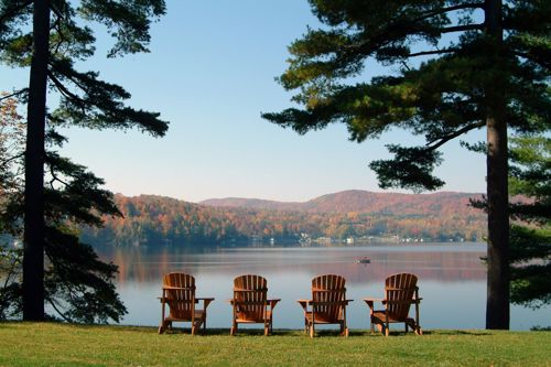 Camp chairs overlooking a lake on a sunny day
